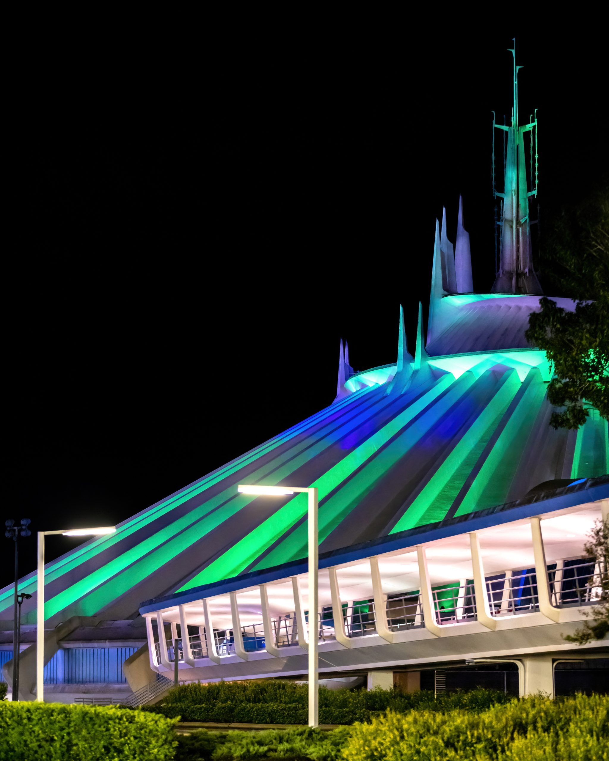 Space Mountain at Disney World, lit up green and blue at night