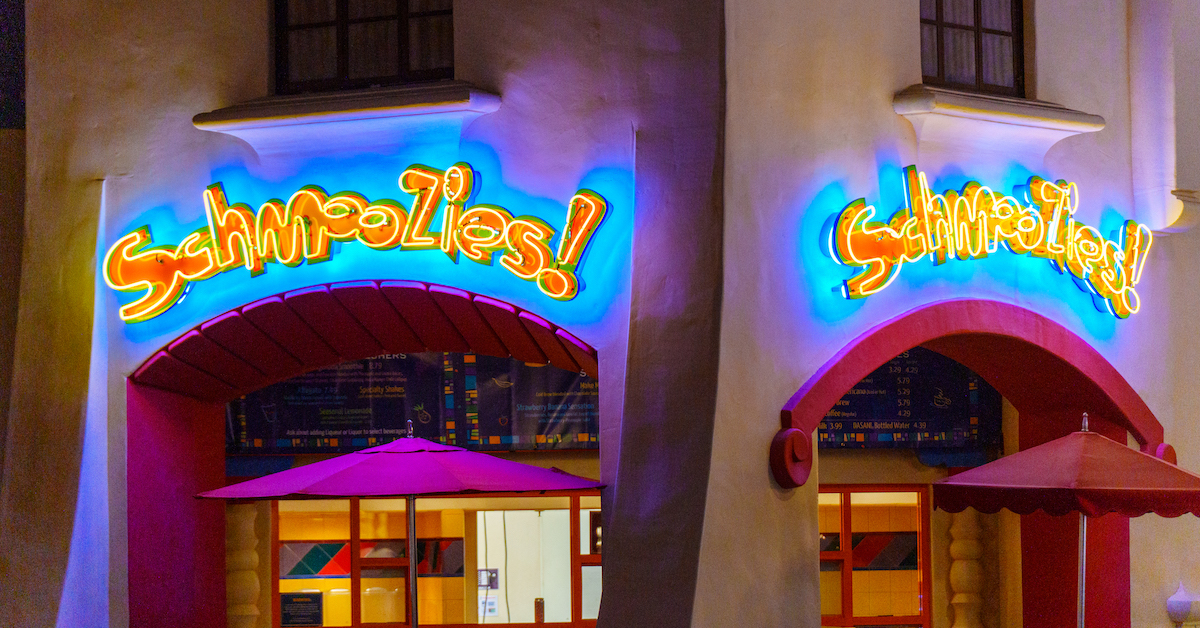 Schmoozies! exterior sign lit up at night