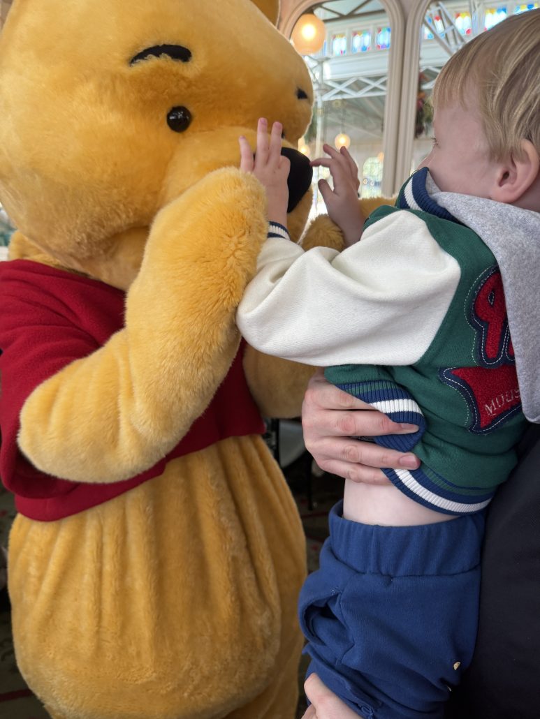 disney world with grandparents, grandson with pooh at crystal palace