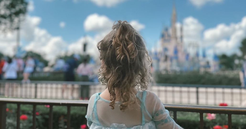best age for disney world, disney world toddler in front of cinderella castle