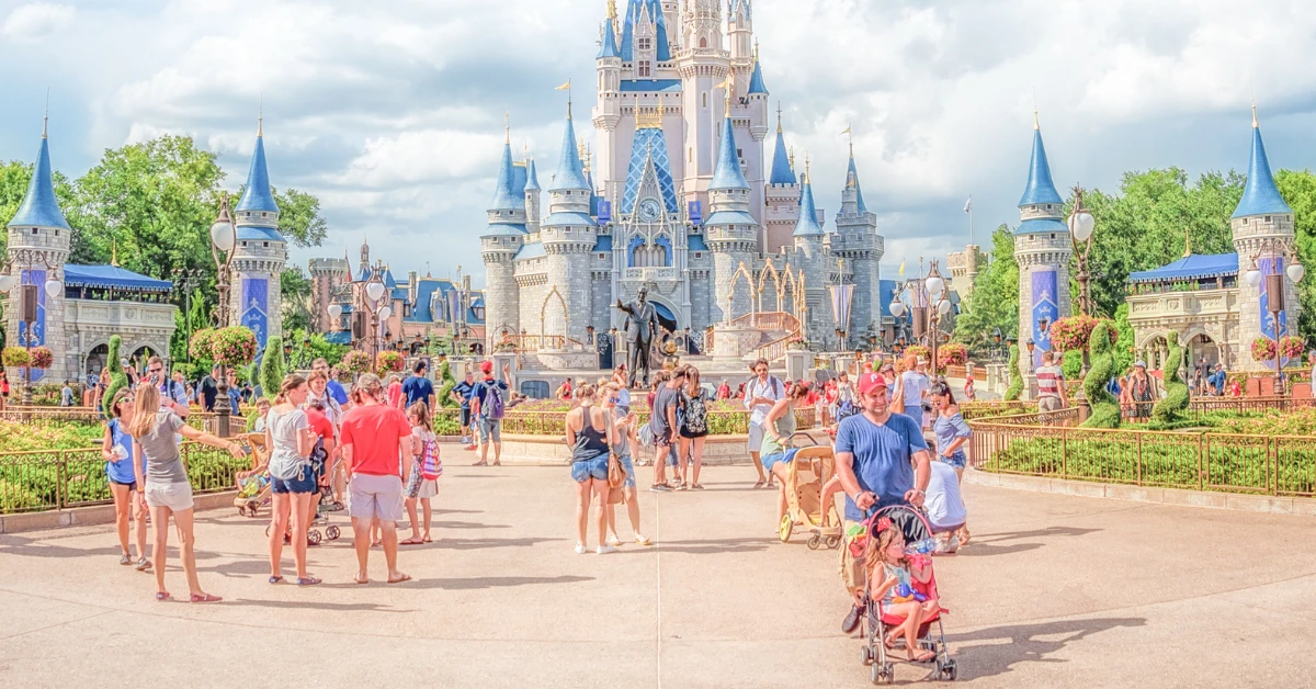 family with stroller in front of cinderella castle